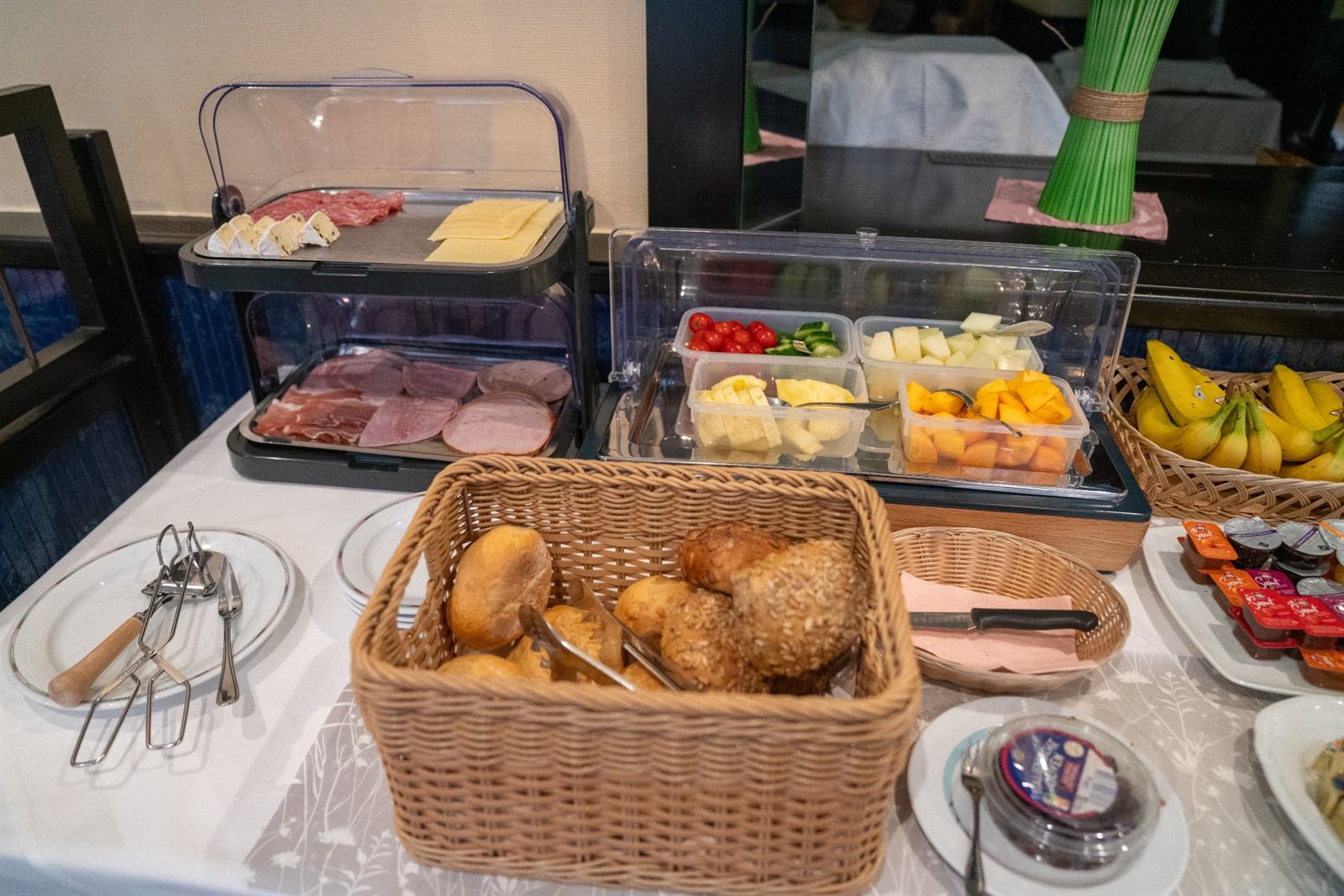 Cold cuts, cheese and a bread basket at the buffet